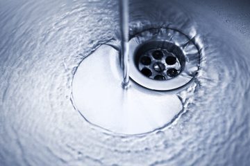 drain-with-water-flowing-from-running-faucet